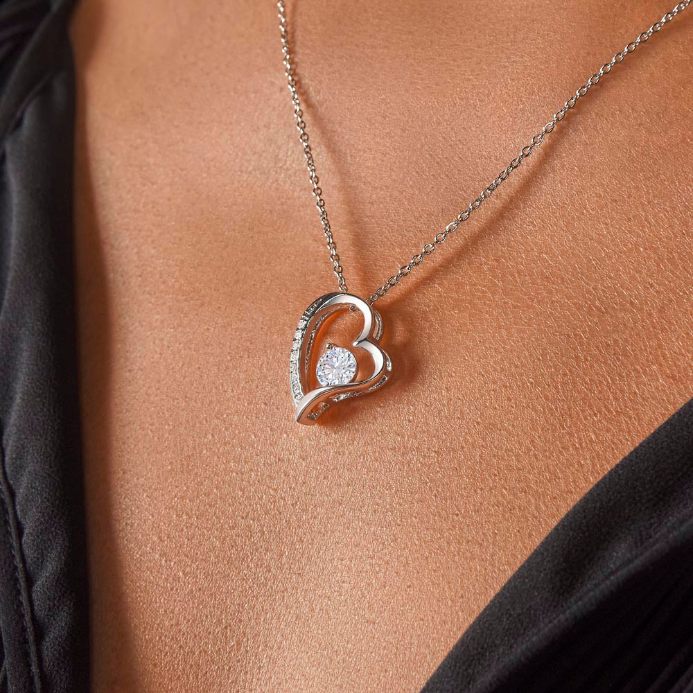 White Crystal and white gold heart decorated with small crystal pendant.